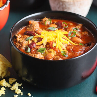 Bowl of Cowboy Chili topped with shredded cheese.
