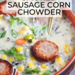 A serving of smoked sausage corn chowder garnished with green onions.