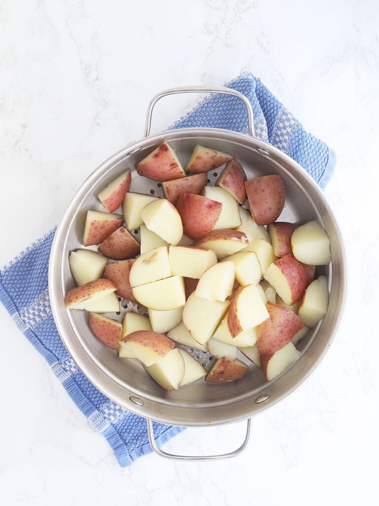 Cooked red skin potatoes in a colander.