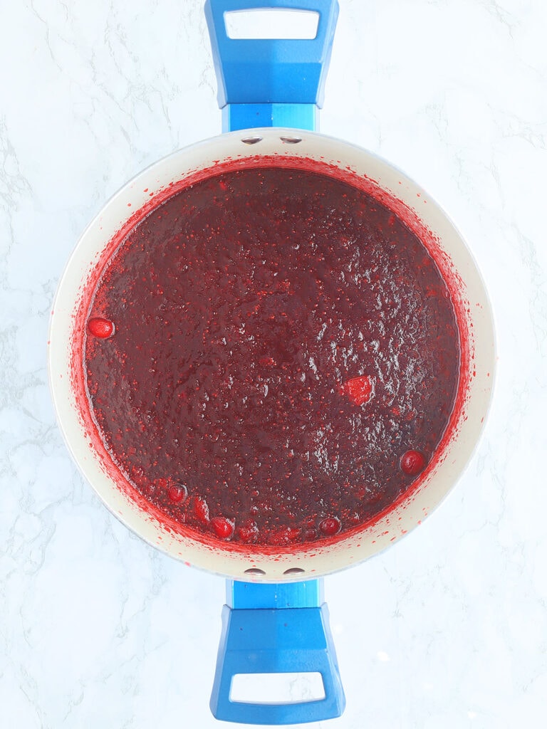 Finished strawberry cranberry jam in a large stock pot.