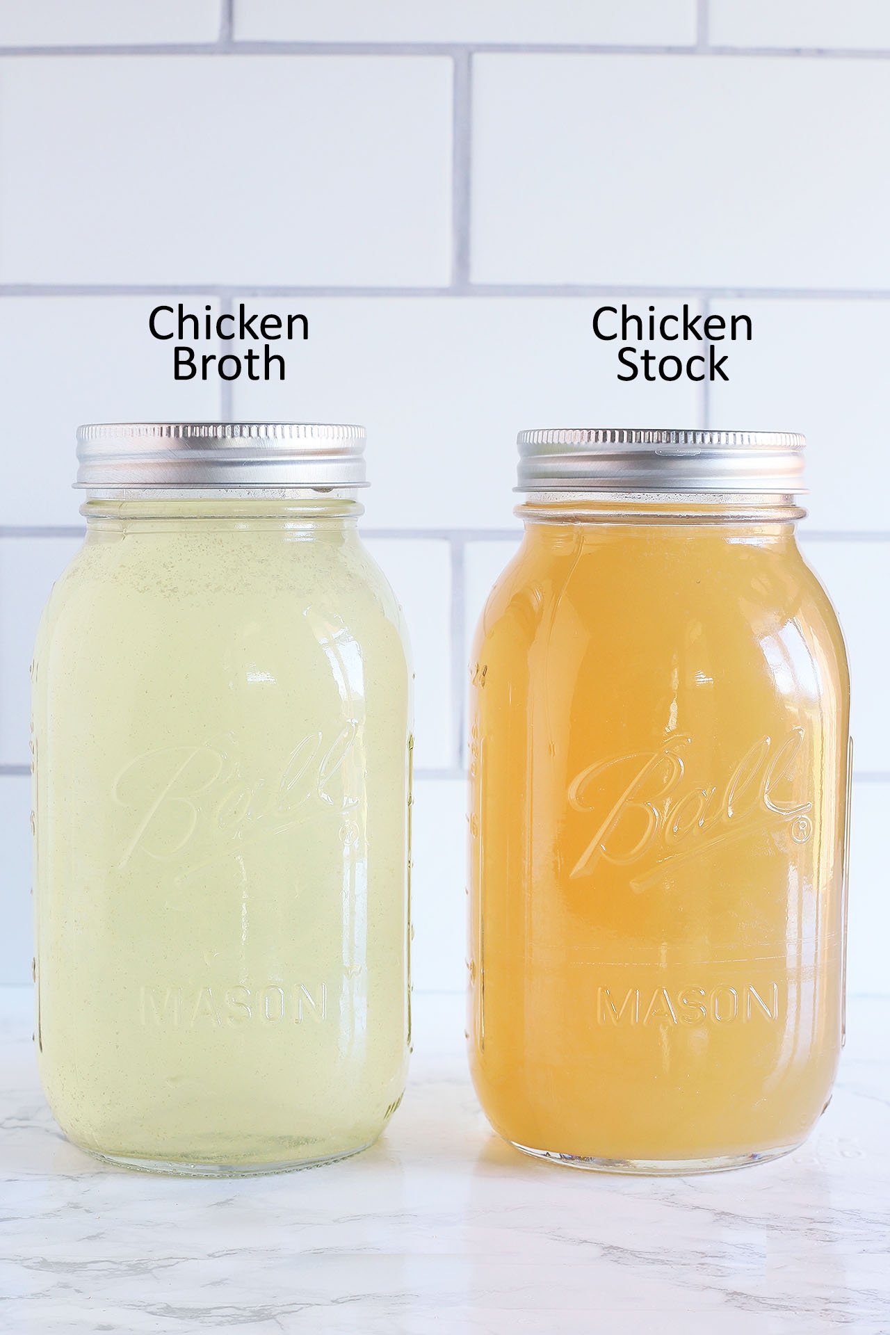 Side-by-side comparison of a jar of chicken broth and chicken stock. The jar of chicken broth is pale yellow. The jar of chicken stock is dark yellow.