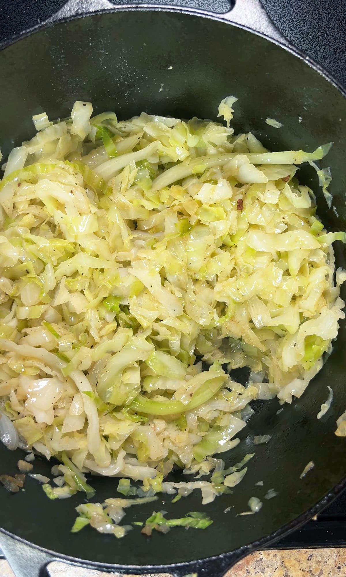 Fried cabbage in a large Dutch oven.