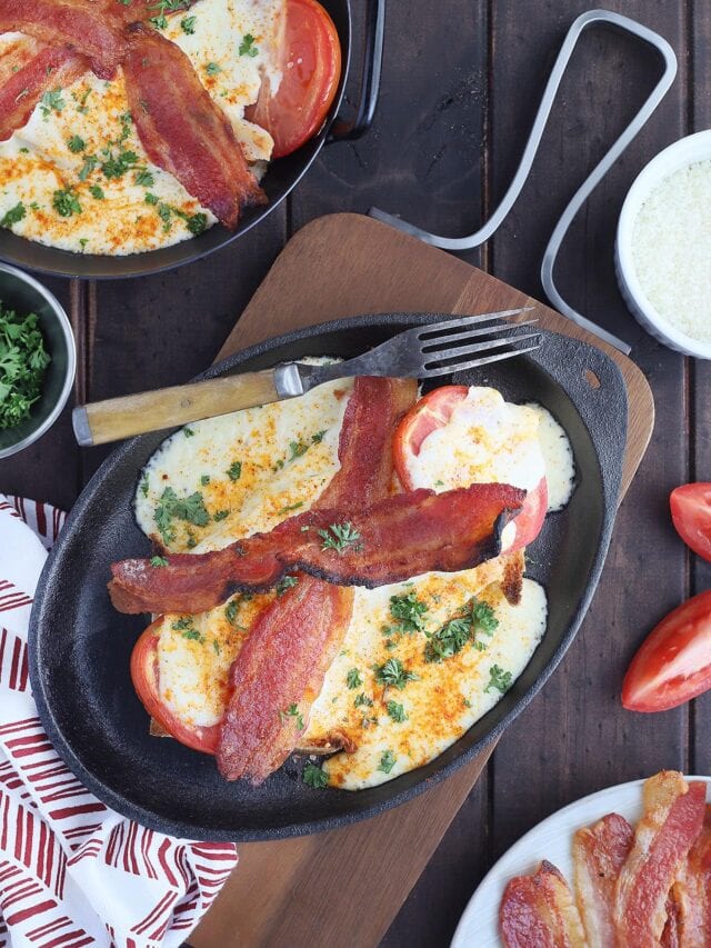 Kentucky Hot Brown sandwich on a cast iron tray with a fork on the side.
