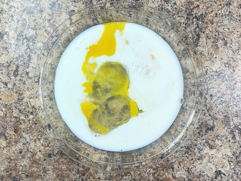 Eggs and milk in a shallow dish.