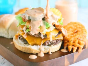 Hamburger with smash burger sauce dripping down the sides.