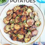 Serving plate of crispy fried Blackstone potatoes garnished with chopped parsley.