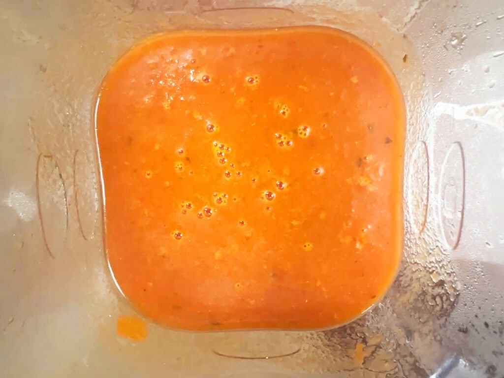 Tomato basil puree in a blender.