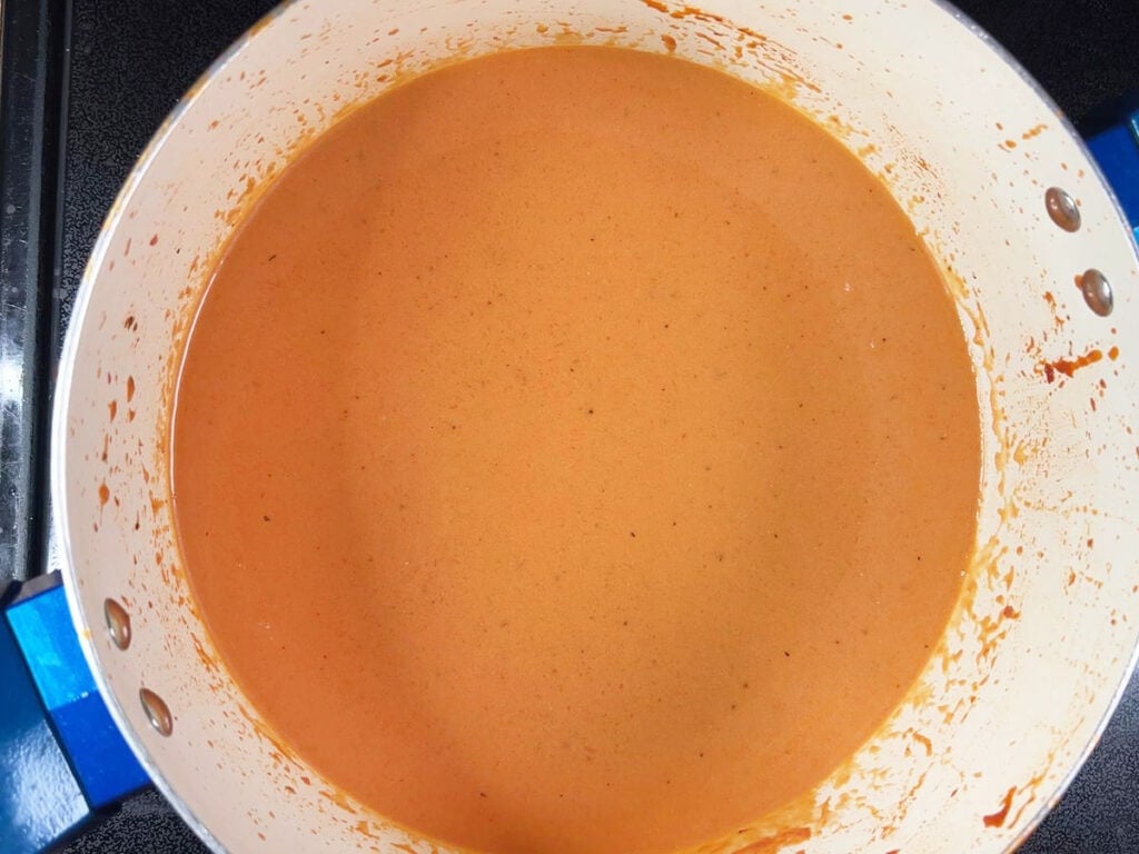 Finished tomato basil bisque in a stock pot.