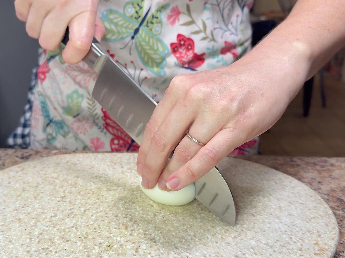 Cutting a hard boiled egg in half.