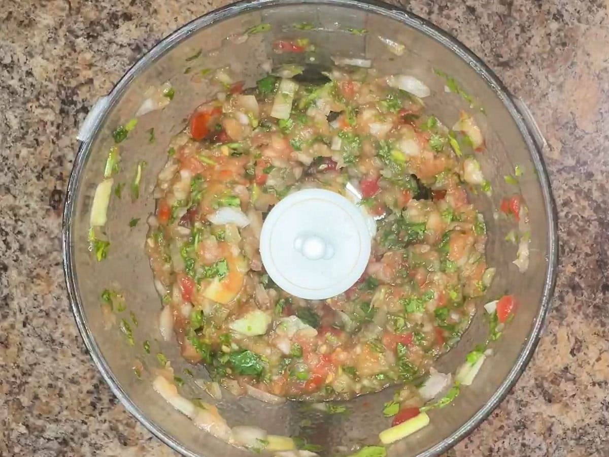 Cilantro, onion and tomatoes chopped in a food processor.