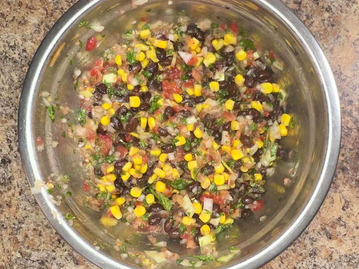 Black bean salsa ingredients mixed together in a mixing bowl.