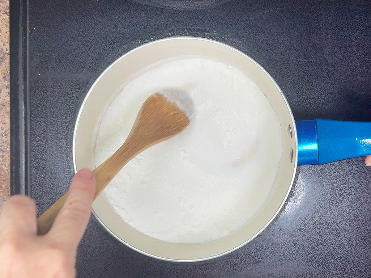Stirring together sugar and cornstarch in a medium saucepan.