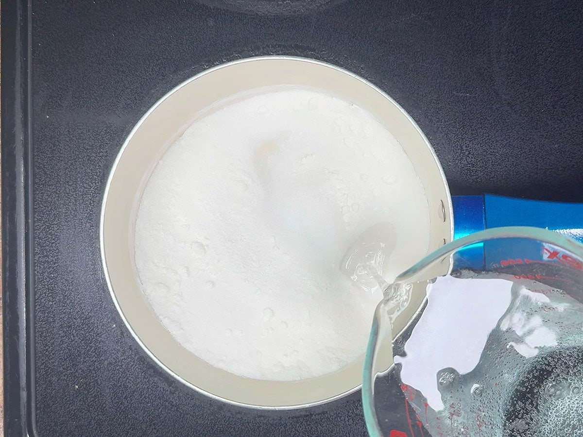 Adding lemon-lime soda to the sugar and cornstarch in a medium saucepan.