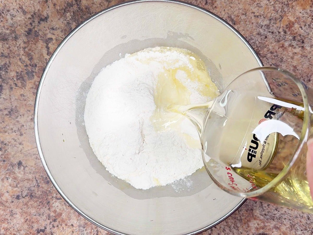 Adding oil to the white cake mix.