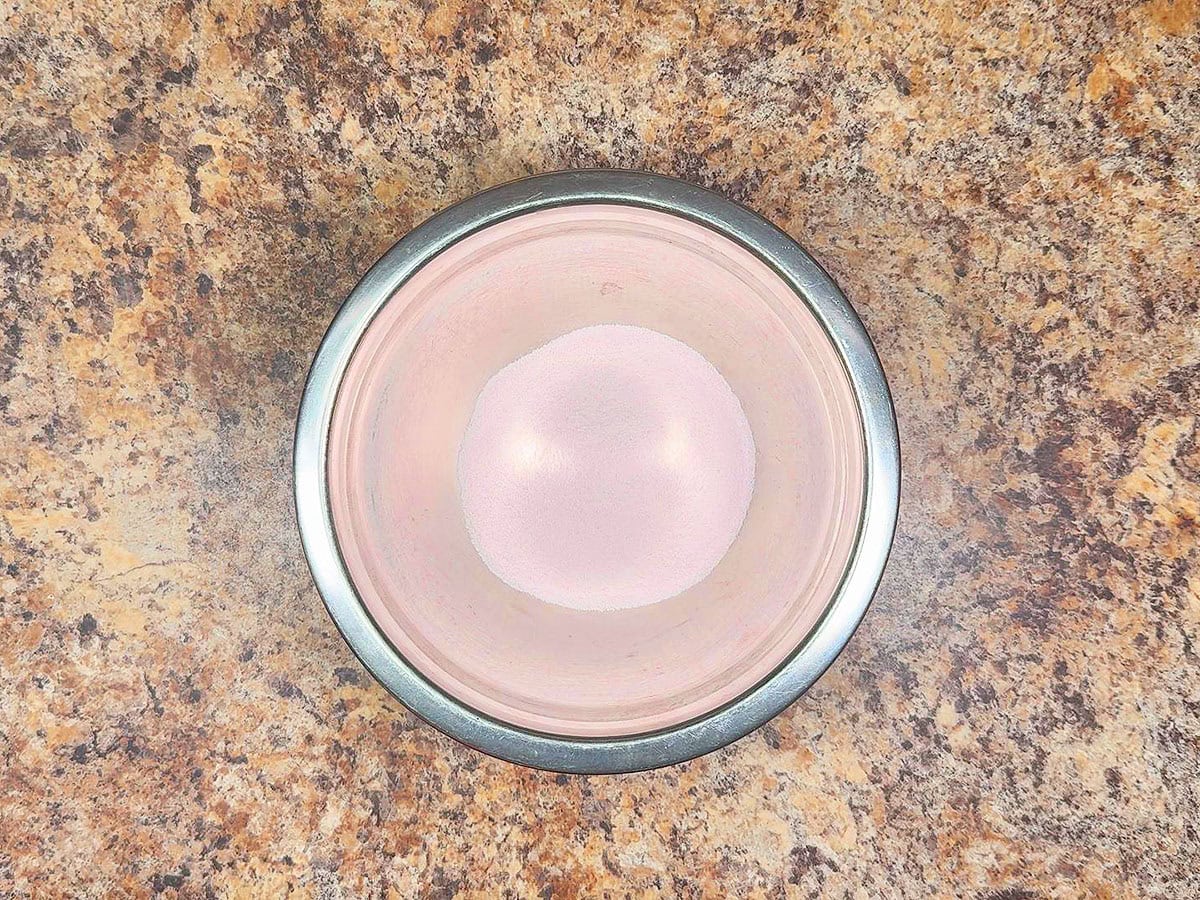 Strawberry gelatin powder in a small mixing bowl.