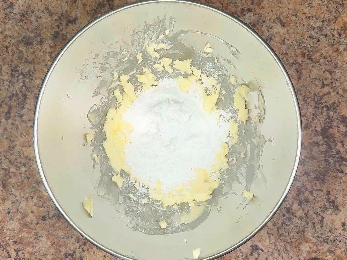 Adding once cup of powdered sugar to the whipped butter.