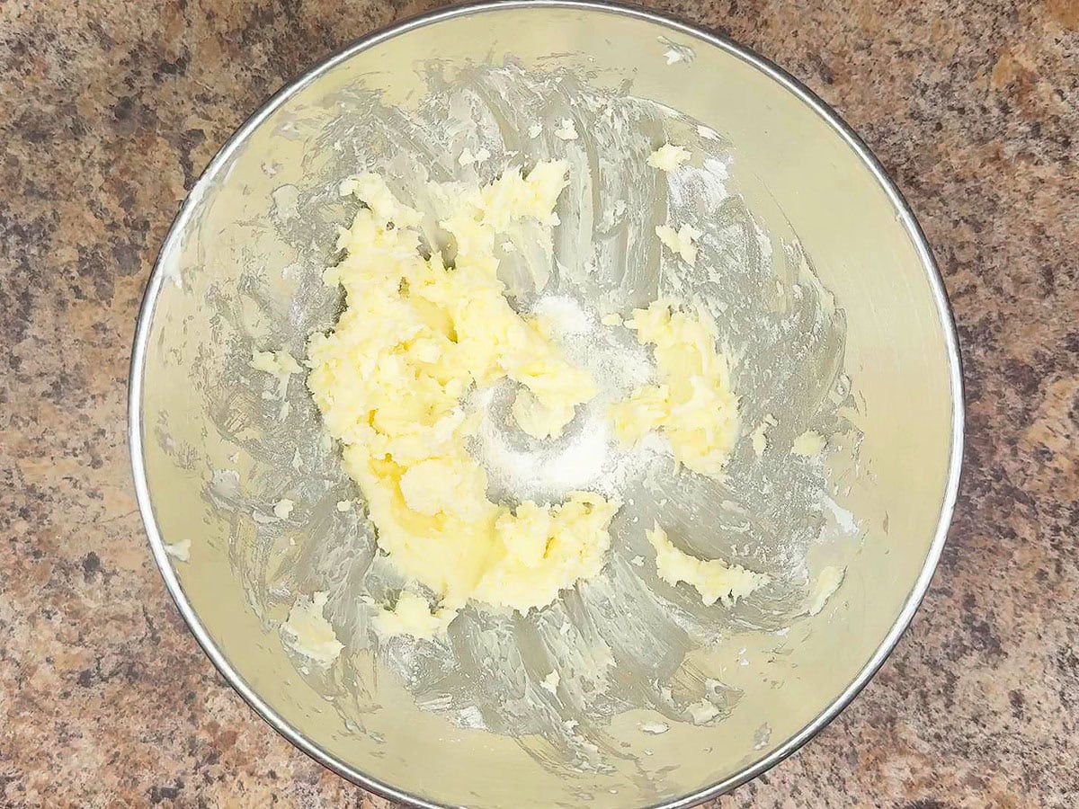 Buttercream icing after one cup of powdered sugar have been added.