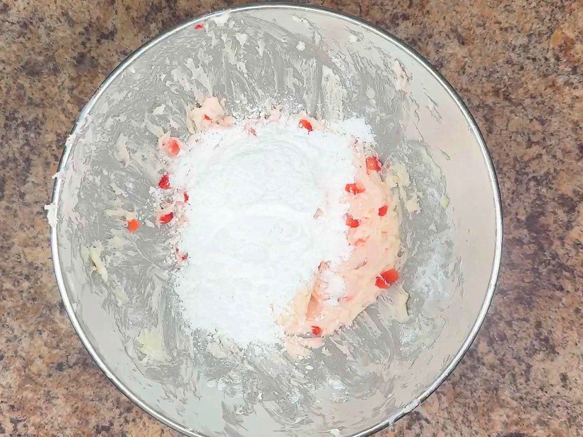 Third and last cup of powdered sugar added to the buttercream frosting.