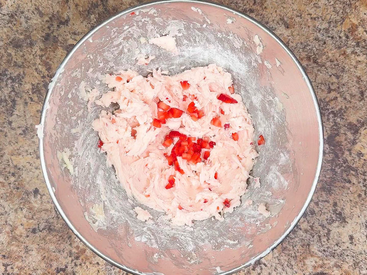 Third and last tablespoon of diced strawberries added to the buttercream frosting.