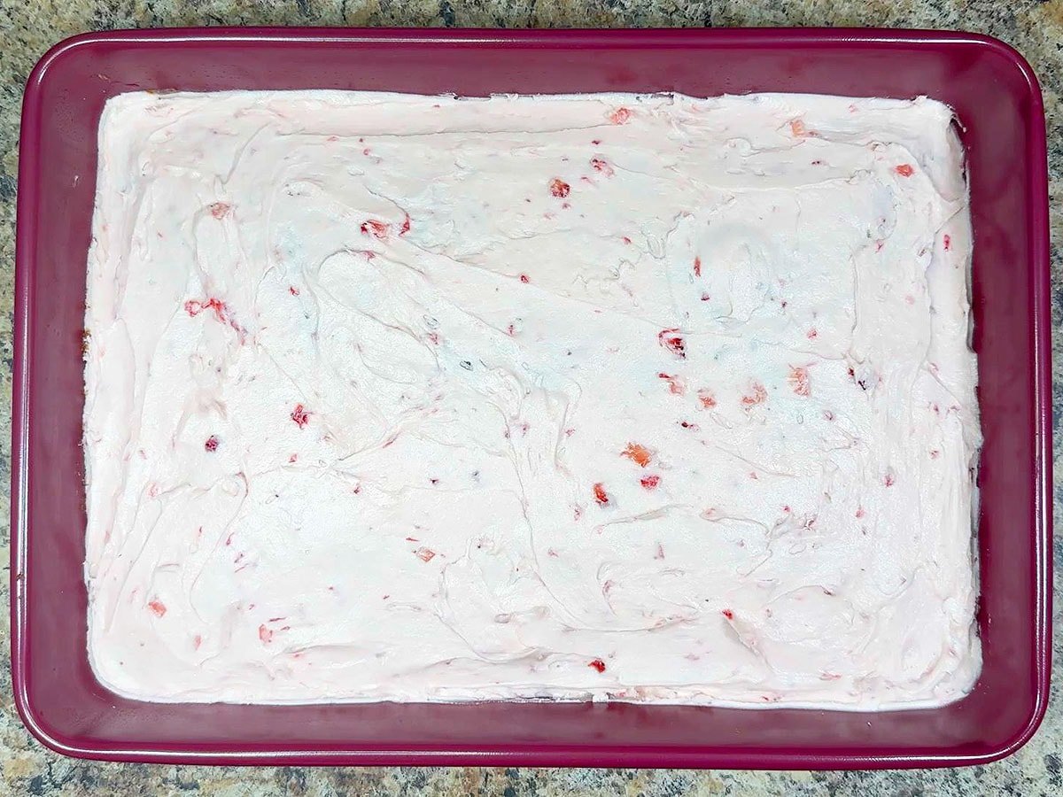 Strawberry sheet cake decorated with the strawberry buttercream frosting.