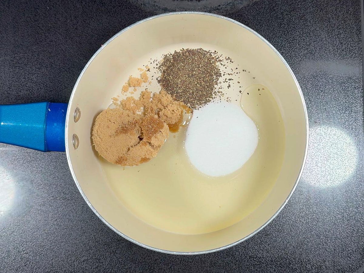 Brown sugar, salt, ground black pepper, and oil in a medium saucepan.