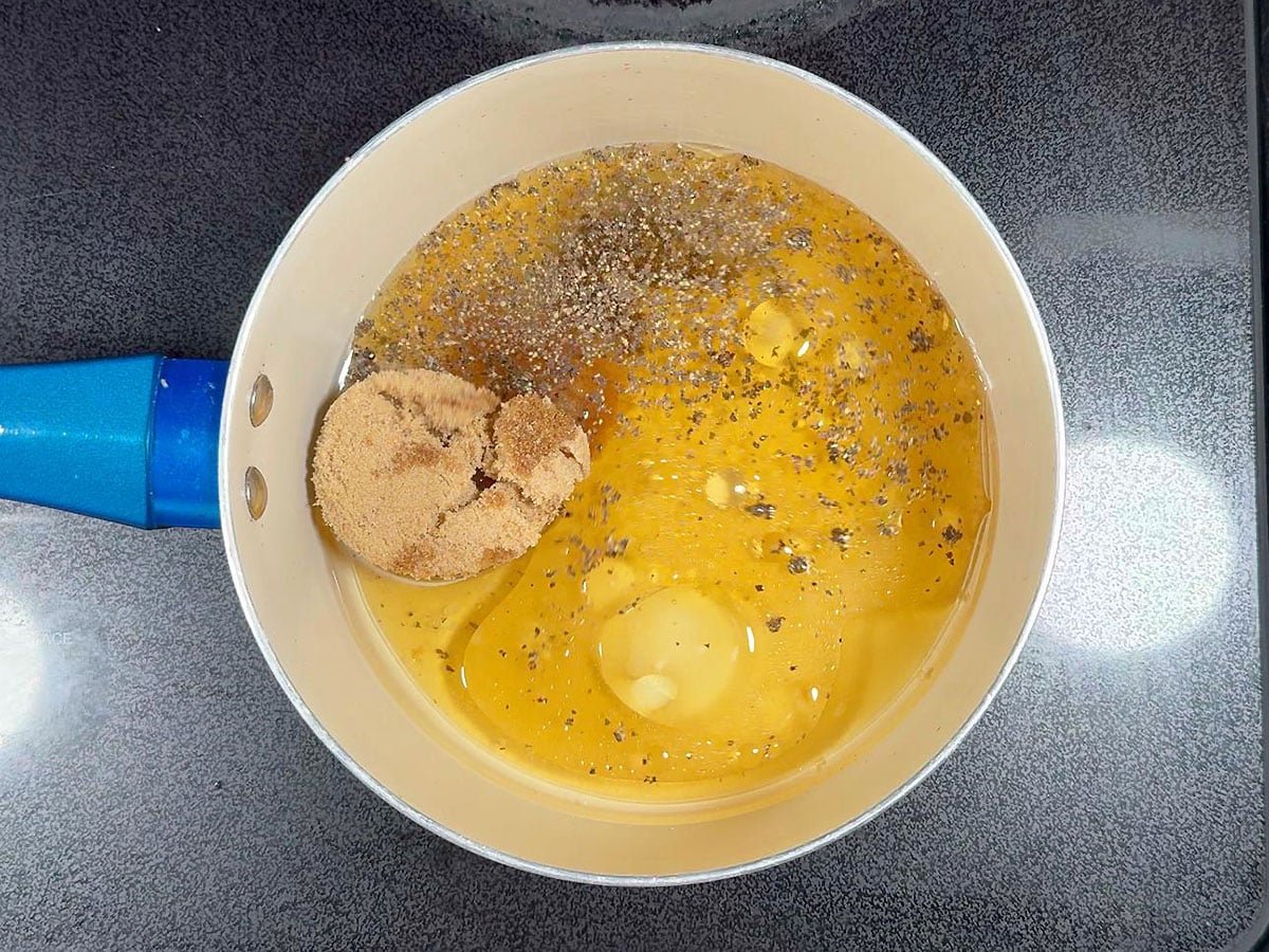Brown sugar, salt, ground black pepper, oil, and apple cider vinegar in a medium saucepan.