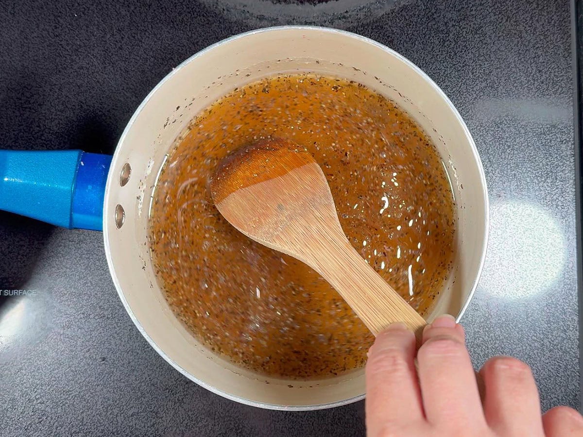 Heating the apple cider vinegar chicken marinade over medium low heat until the sugar is dissolved.