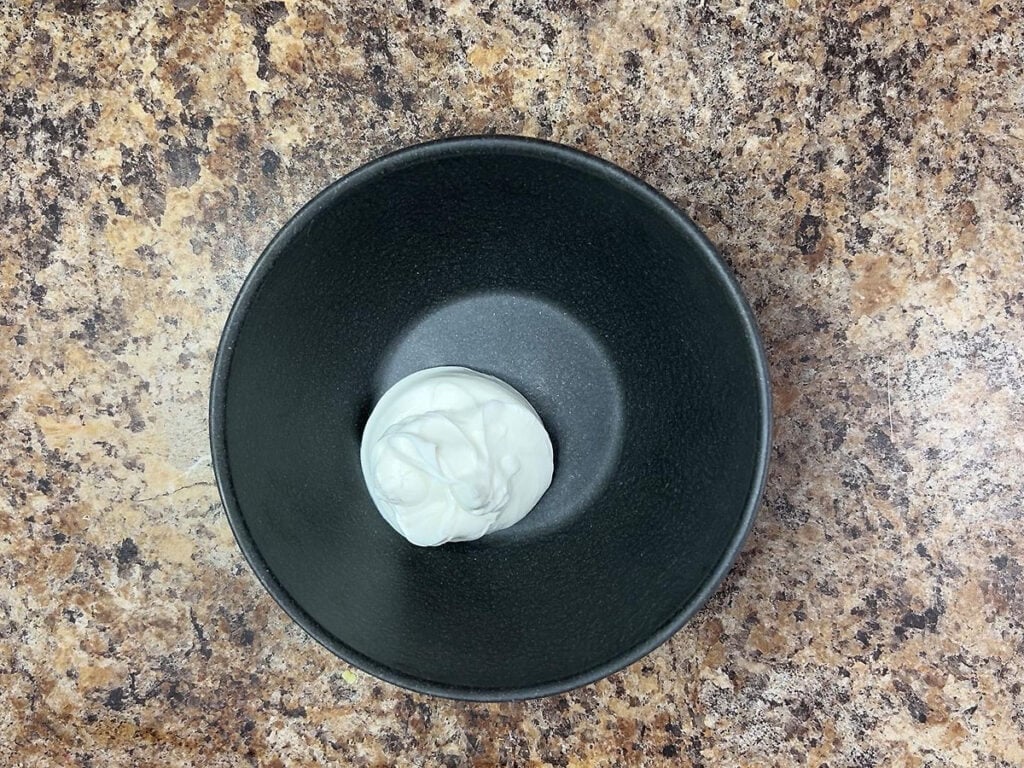 Sour cream in a small mixing bowl.