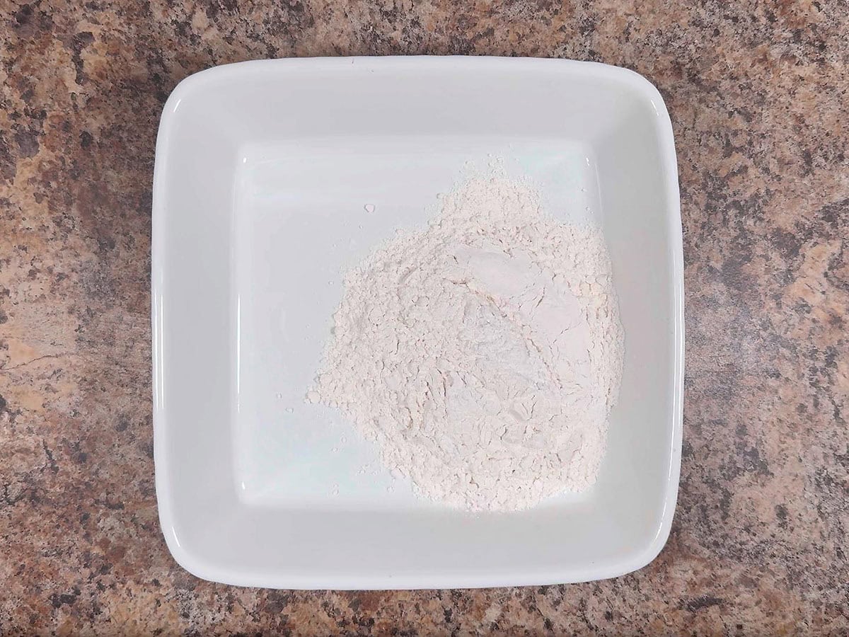 Flour in a shallow dish.