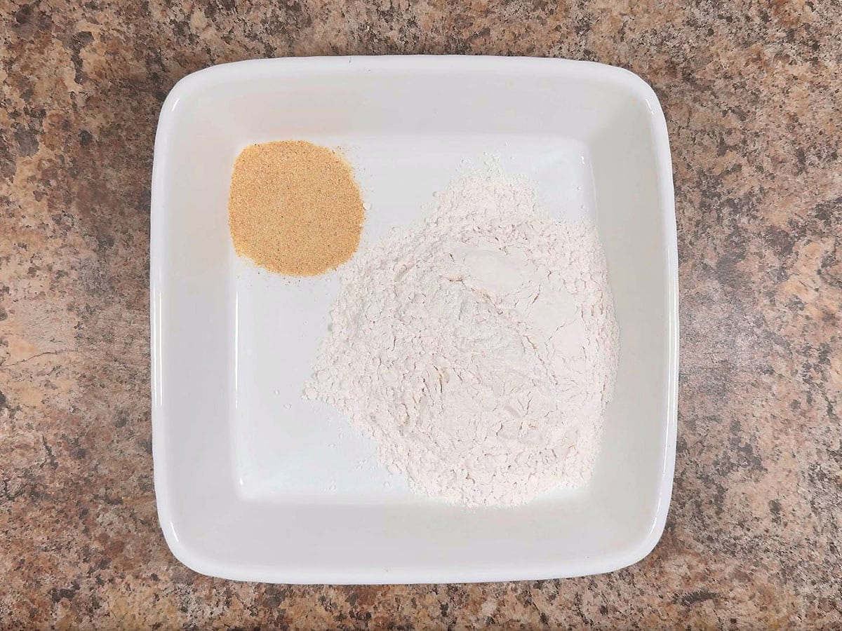 Garlic powder and flour in a shallow dish.