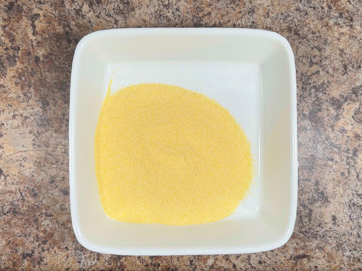 Cornmeal in a shallow dish.