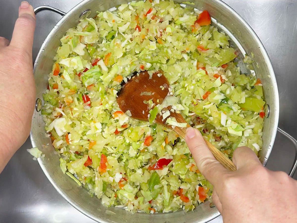 Pressing out the excess water in the chopped vegetables.