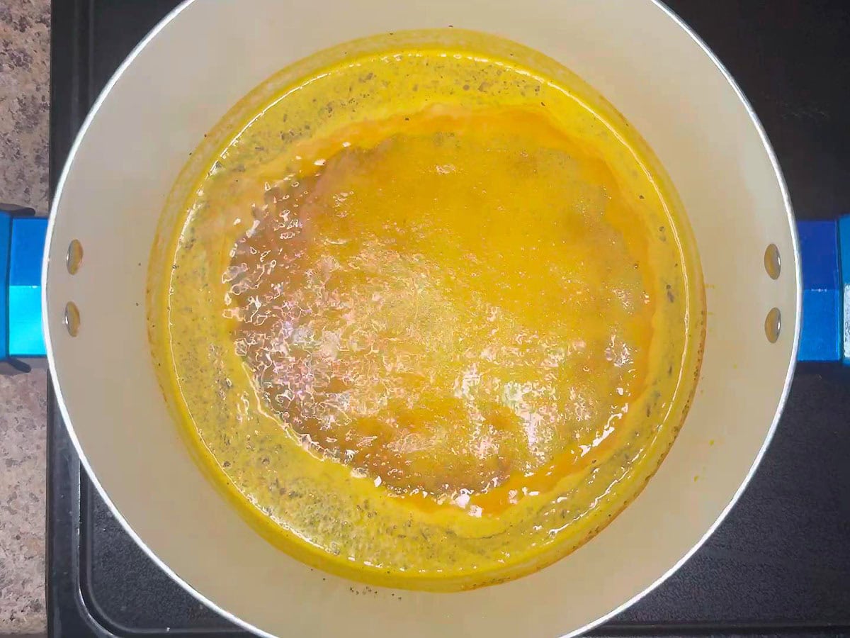 Chow chow brine simmering in a stockpot on the stove.