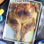 Smoked spatchcock chicken on a tray with a skillet of cornbread, a bowl of pasta salad, and glasses of sweet tea on the side