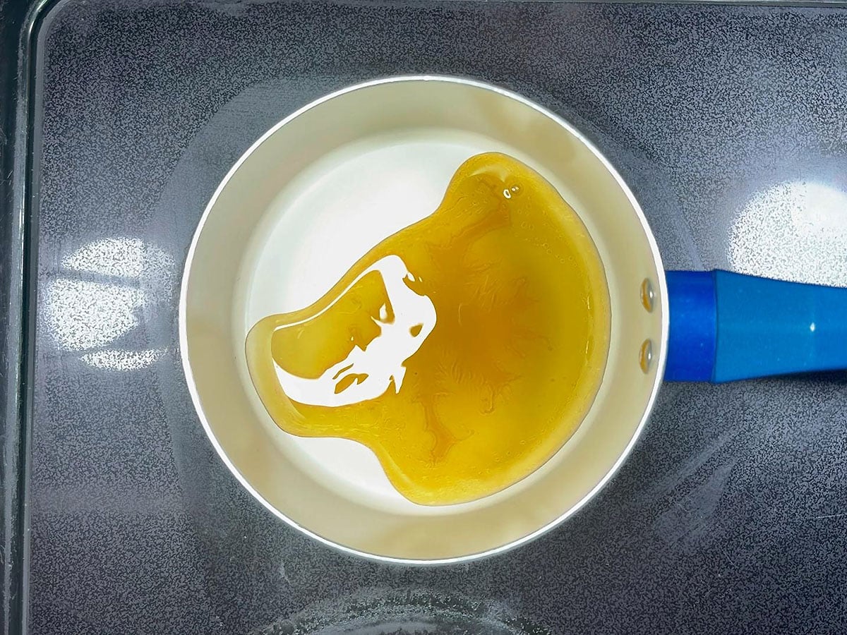 Apple cider vinegar and maple syrup in a saucepan.