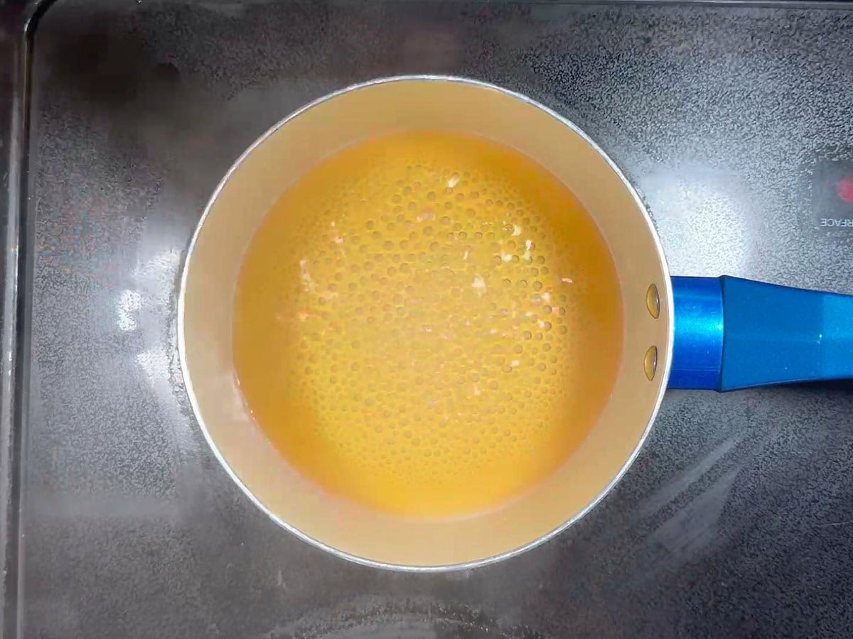 Bringing the maple glaze to a simmer.