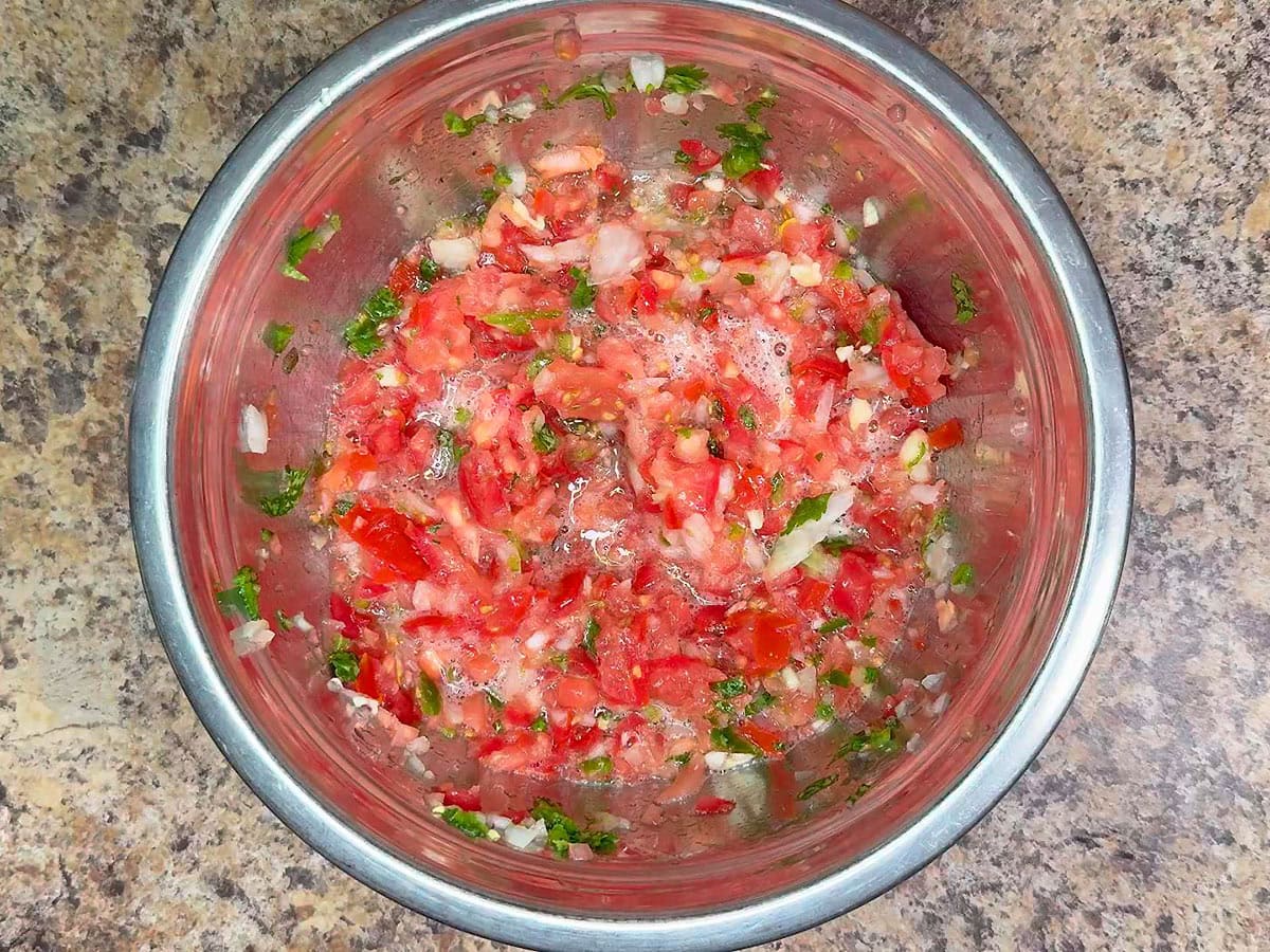Finished garden salsa in a metal mixing bowl.
