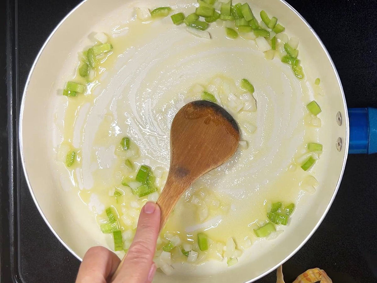Sauteing the onion and celery in butter.