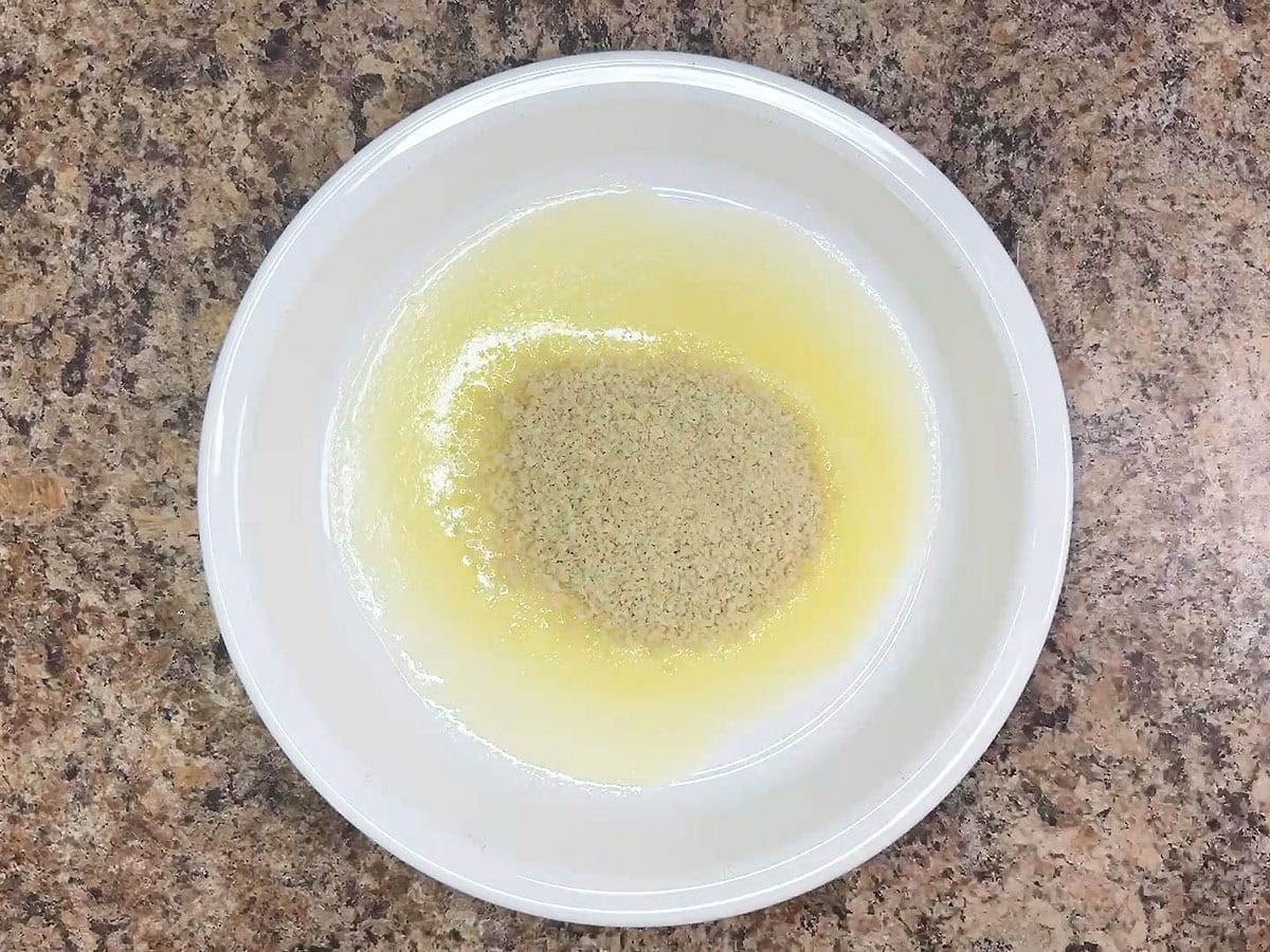 Melted butter and panko bread crumbs in a shallow dish.