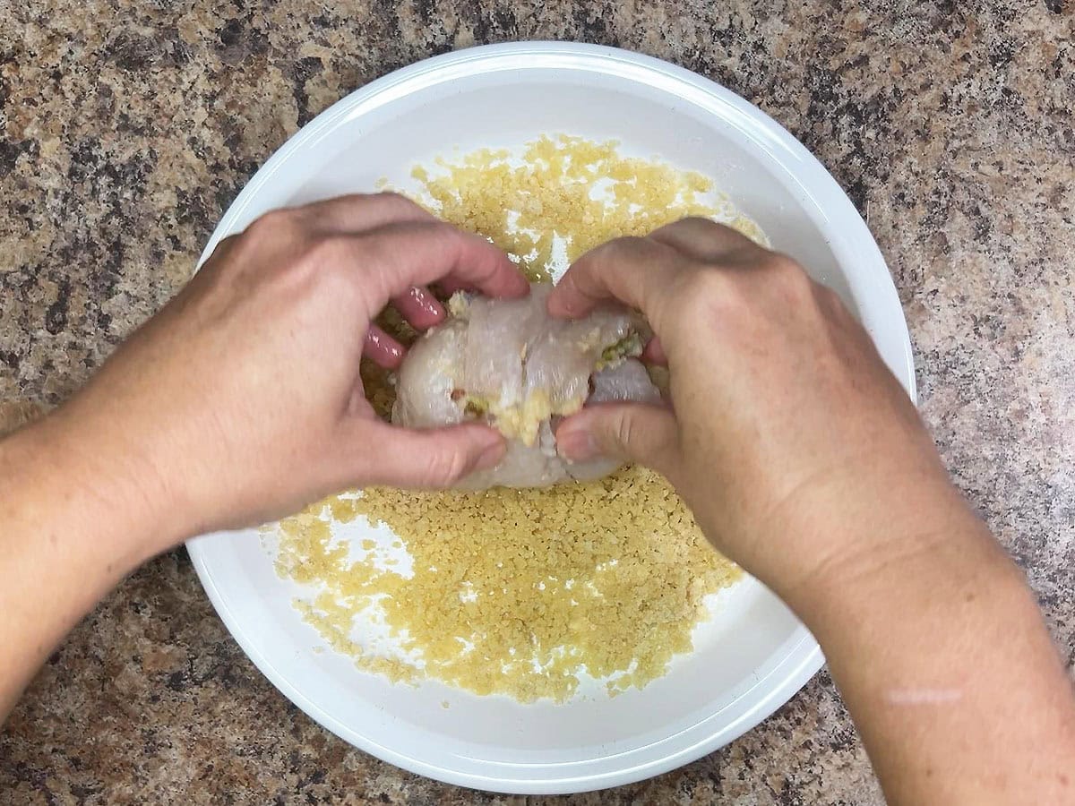 Rolling the catfish fillets in the buttered panko bread crumbs.