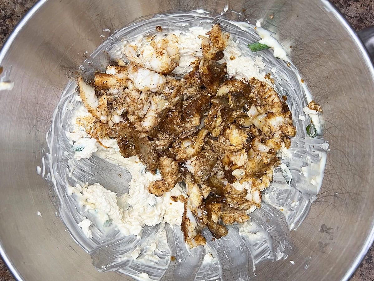 Cooked and chopped catfish added to the remaining dip ingredients in a mixing bowl.