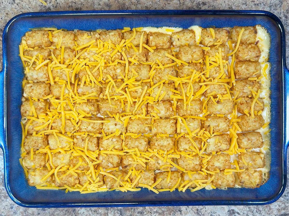 Baked casserole topped with shredded cheddar cheese.