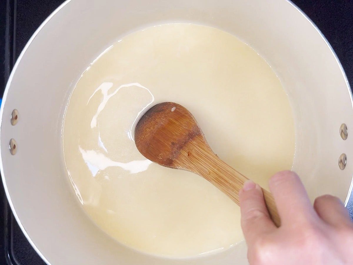 Stirring the chicken broth, flour and melted butter together until smooth.