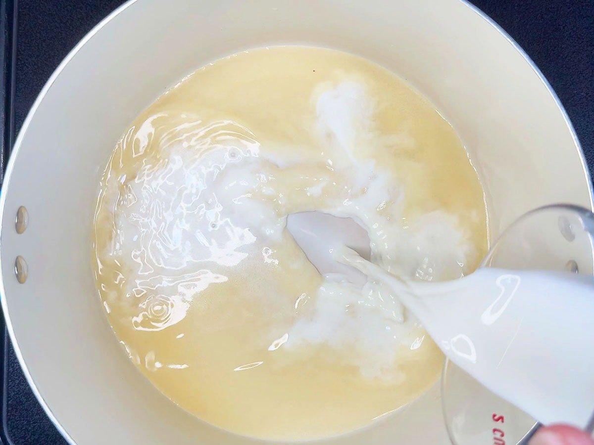Adding milk to the flour mixture.