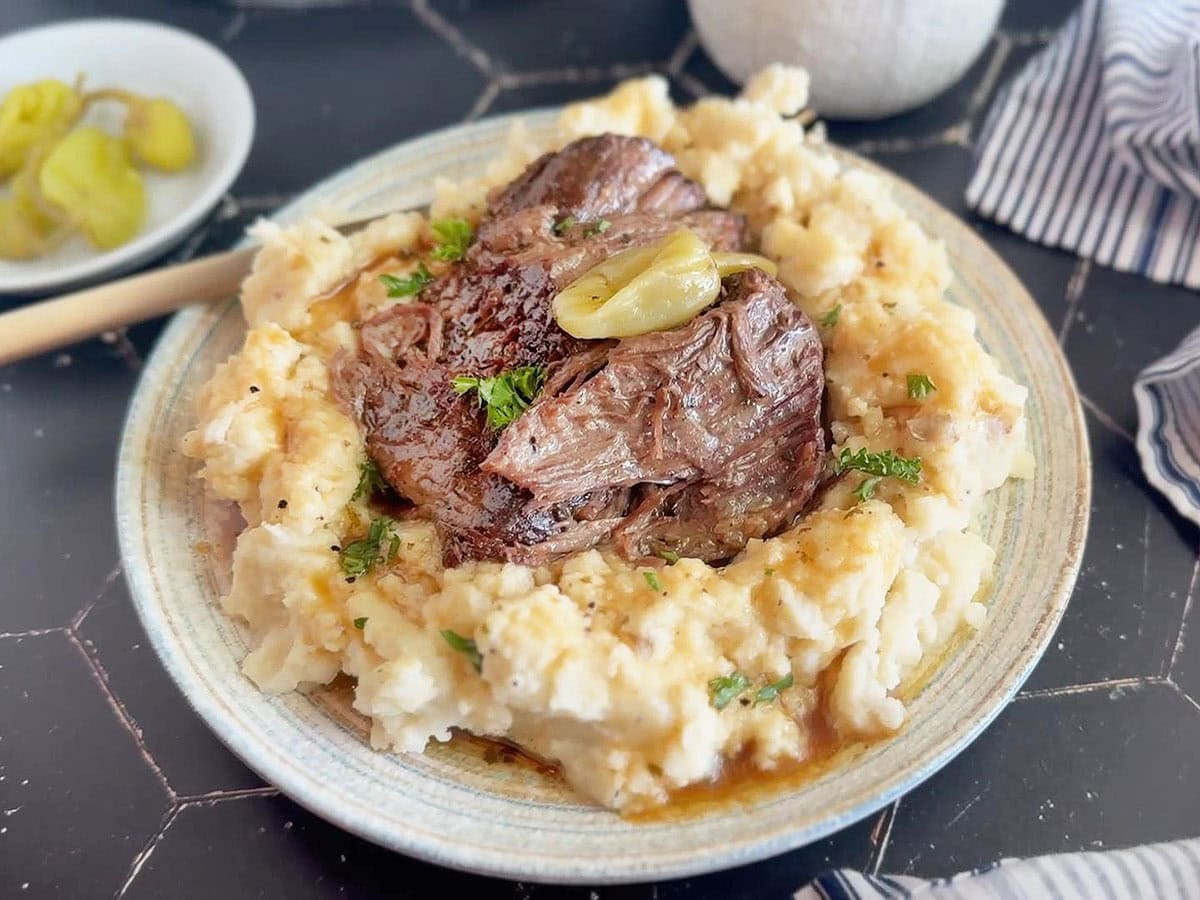 Shredded pot roast on a bed of mashed ptoatoes.