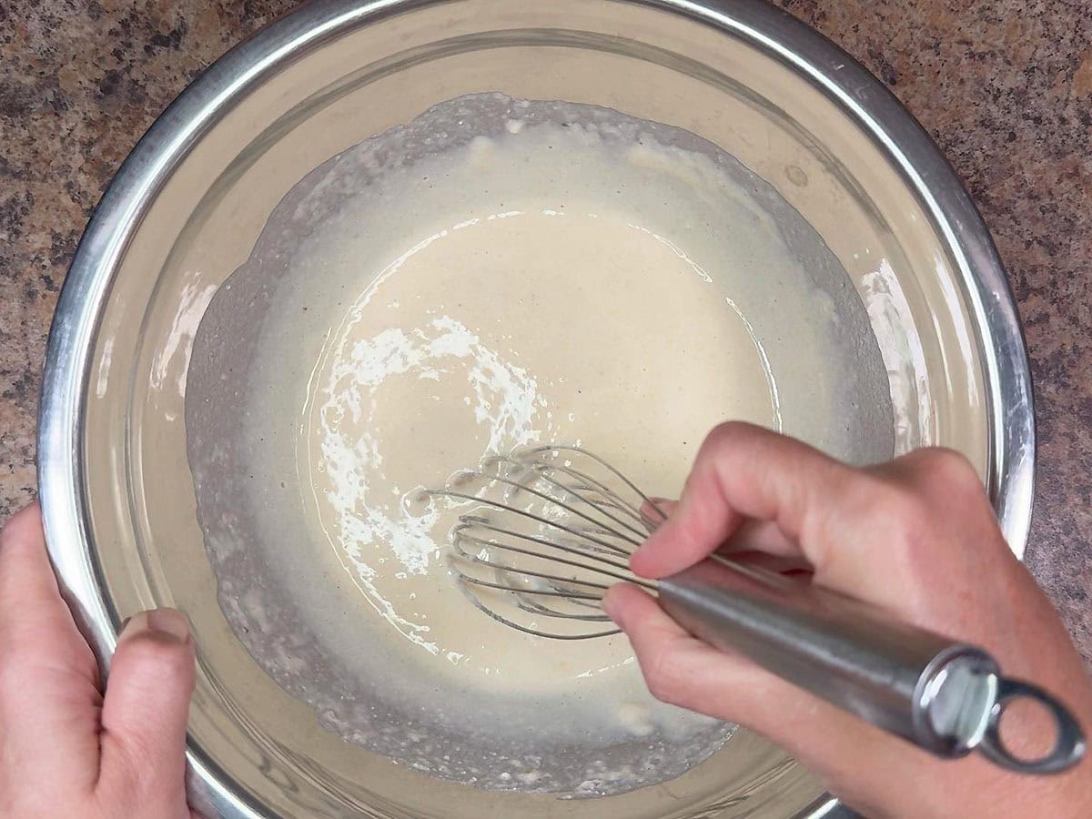 Whisking together the wet and dry ingredients for the mini corndog batter.