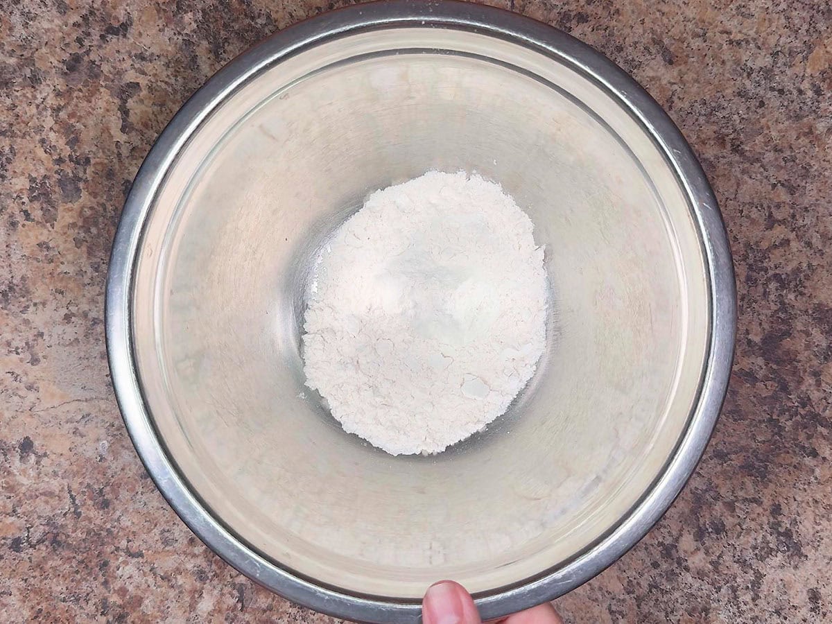Measuring out flour in a separate mixing bowl.