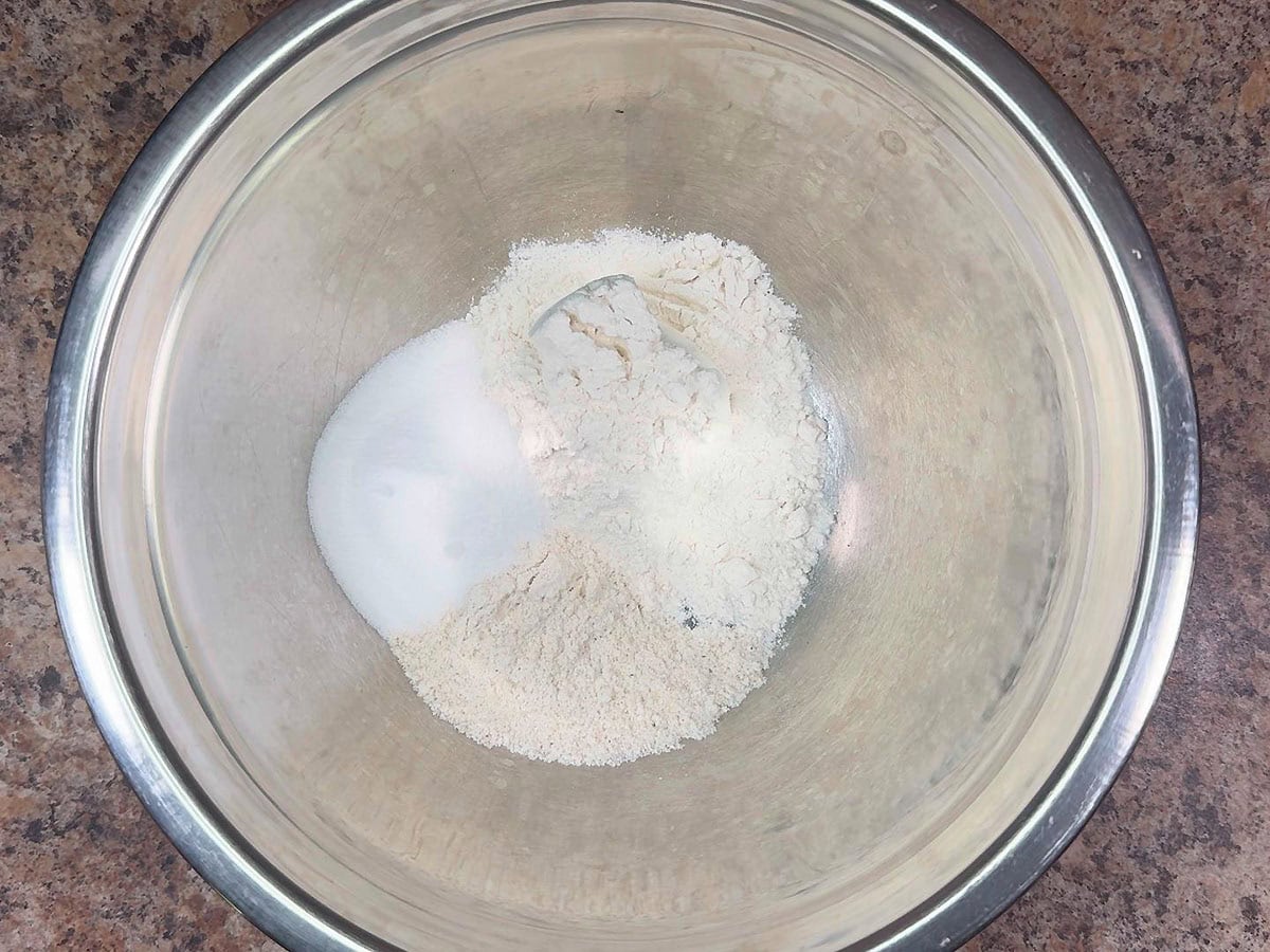 Flour, white cornmeal, and sugar in a large mixing bowl.