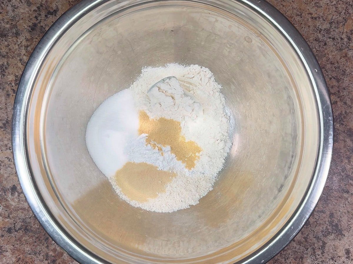 Flour, white cornmeal, sugar, baking powder, salt, garlic powder, and onion powder in a large mixing bowl.