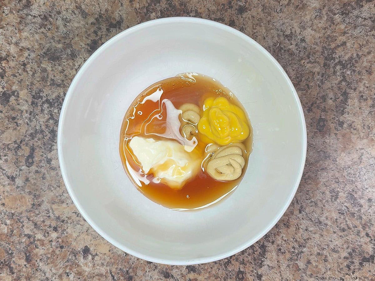 Honey mustard sauce ingredients unmixed in a small bowl.